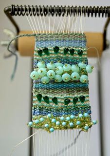 a close up of a weaving machine with beads on it