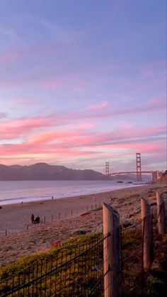 A sunset at the beach with Golden Gate Bridge in the background San Francisco Sunset, Presidio San Francisco, Pastel Nature, Sf Wallpaper, California Coast Road Trip, Sunset Wallpaper