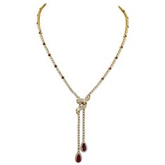 A beautiful and elegant necklace adorned with baguette and round diamonds. Two pear-shape rubies suspending from the chain weighing around 2 carats each. 24 square-cut rubies are set all over the chain. Approximate total weight is 3.6 carats, 0.15 carat each ruby. Baguette and round diamonds weighing a total of approximately 18-20 carats. The diamonds are equivalent to G-H colors, VS-SI clarity. The metal is 18k yellow gold, gross weight 40.77 grams. All rubies and diamonds in the necklace are n Yellow Diamond Necklace, Rubies And Diamonds, Ruby And Diamond Necklace, Drop Necklaces, Gold Drop Necklace, Diamond Drop Necklace, Gold Diamond Necklace, Elegant Necklace, White Gold Necklaces