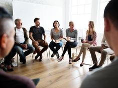 a group of people sitting on chairs in a room