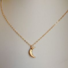 "Another version of our mini moon, this necklace features the tiniest of hand-formed bronze crescent moons. It's so delicate and dainty-a great every day piece. Layer it with larger pieces for a bohemian look. The moon measures approximately 1/2\" long and the 14k gold filled chain is adjustable from 16-18\"." Delicate Crescent Moon Charm Necklace, Dainty Crescent Moon Charm Necklace, Delicate Half Moon Necklace With Moon Phase Detail, Delicate Half Moon Necklace With Moon Phase, Delicate Half Moon Phase Necklace, Minimalist Crescent Brass Necklaces, Delicate Moon Phase Charm Necklaces, Elegant Brass Moon Charm Necklace, Elegant Brass Charm Necklace With Moon Charm