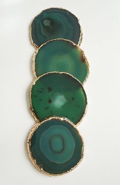 three pieces of green agate glass sitting on top of each other