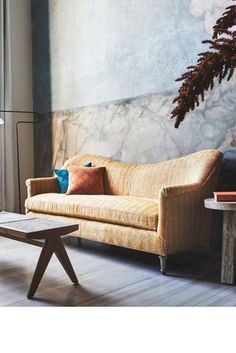 a living room scene with focus on the couch and coffee table in the foreground