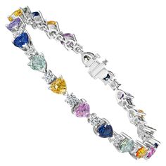 • 18KT White Gold • 13.48 Carats • 7" Long • Number of Round Diamonds: 20 • Carat Weight: 2.91ctw • Number of Heart Shape Sapphires: 20 • Carat Weight: 10.54ctw This beautiful bracelet contains a row 20 heart shape sapphires & round white diamonds with a combining total weight of 13.45 carats. The sapphires range in color from blue, yellow, teal, green, and pink. Set in 18KT white gold, this bracelet measures 7” long. Each stone has been carefully matched and set by hand in New York City. Modern Bracelets, Color Heart, Pink Set, Colorful Heart, Sapphire Diamond, White Diamonds, Teal Green, Heart Shape, Beautiful Bracelet