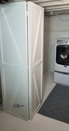 there is a washer and dryer in this small room with the doors open