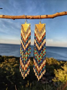 "\"Amanda\" ♀ Bohemian Native American inspired beaded earrings handmade with natural stones, glass beads, brass, and sterling silver. ♀ Stones: Lapis Lazuli ♀ Drop Height: 5 in. ♀ Beads: Toho, Miyuki, Czech ♀ Ear Wire: Sterling Silver ♀ Thread: Nylon ♀ Nickel Free ♀ Ships within 5-7 days \"There is always light. If only we're brave enough to see it. If only we're brave enough to be it.\"- Amanda Gorman" Gold Artisan Beaded Fringe Earrings, Bohemian Handwoven Brass Beaded Earrings, Bohemian Lapis Lazuli Earrings As Gift, Native American Dentalium Earrings, Inuit Beaded Earrings, Handmade Lapis Lazuli Bohemian Beads, Handmade Lapis Lazuli Bohemian Earrings, Bohemian Lapis Lazuli Earrings, Chevron Earrings