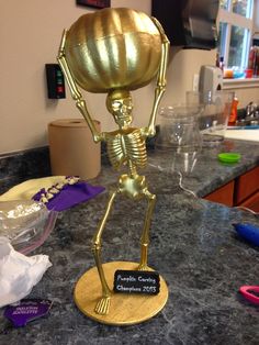 a gold statue on top of a counter in a kitchen