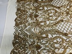 gold sequins and lace on white fabric