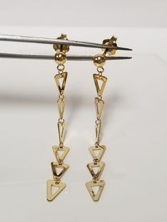 "Thanks for shopping our vintage estate store. We tend to sell well below wholesale and truly hope you enjoy all of our items. Many of the items are one of a kind, so please enjoy scrolling through the pictures and hopefully something will catch your eye. Brown spots are from camera or reflections. Beautiful 14k yellow gold triangle drop dangle earrings. Length: 2\" Width: 1/4\" 4mm Weight: 1.97 grams Nice earrings. Marked 14k and you will love these. As with most estate items there may be some wear on item. We do not sell new items, nor do we charge new retail prices." Vintage 14k Gold Dangle Earrings, Vintage Gold Long Drop Earrings, Vintage 14k Gold Dangle Jewelry, 14k Gold Pierced Linear Earrings For Anniversary, 14k Gold Dangle Linear Earrings For Anniversary, 14k Stamped Dangle Earrings For Anniversary, 14k Gold Dangle Earrings For Anniversary, Nice Earrings, Gold Triangle