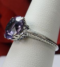 "Natural Purple Amethyst Ring Button Design#12 This is an Art Nouveau/Deco reproduction ring in sterling silver set with a stunning 3.3ct natural purple amethyst gemstone. The round full cut gem is 10mm in diameter (3/8th\"). The inside of the band is marked 925 for sterling. Notice the beautiful craftsmanship of the silver filigree setting. This is an exquisite rendition of an antique style of a ring... and is ready to wear. A gift box is included and the ring will be shipped in it for safekeep Classic Purple Amethyst Round Cut Ring, Classic Purple Amethyst Ring Round Cut, Classic Purple Amethyst Ring With Round Cut, Classic Purple Amethyst Ring, Classic Purple Round Rings, Classic Diamond Cut Purple Amethyst Ring, Classic Purple Round Stone Jewelry, Classic Purple Amethyst Ring With Vs Clarity, Classic Lavender Amethyst Ring With Prong Setting