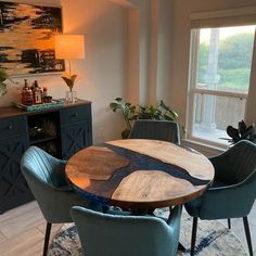 a dining room table with blue chairs around it