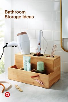 the bathroom storage ideas are organized with bamboo boxes and utensils, such as toothbrushes, hairdryer, and other personal care items