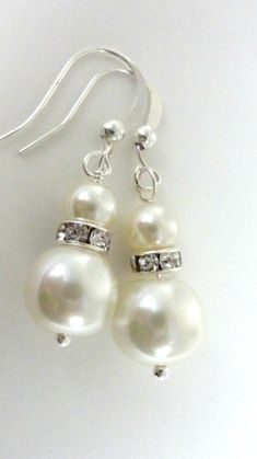 "Bridesmaids earrings ivory white pearl earrings silver rhinestone and ivory dangle drops Lovely white glass pearls are attached to silver rhinestone spacers and small 4mm ivory white pearls, and hang from silver fish hooks. You can also buy the matching necklace at https://www.etsy.com/listing/98611603/flower-necklace-vintage-necklace-white as shown in the second last photo. If you need more than the quantity stated, please feel free to contact me. These earrings measure a bit shorter than 2\" Bridesmaids Earrings, White Pearl Earrings, Ivory Earrings, White Pearl Earring, Fish Hooks, Silver Fish, Necklace White, Silver Rhinestone, Necklace Vintage