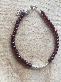 Quality Deep Red Garnet Gemstone Bracelet.  Hill Tribe Sterling Silver Beads. Sterling Silver Clasp. Add Additional Garnet Bracelet as Stacker.  See Listing. Red Rondelle Gemstone Beaded Bracelets, Red Rondelle Gemstone Beads Bracelets, Red Gemstone Beaded Bracelets For Jewelry Making, Red Garnet Round Beads Jewelry, Burgundy Round Beads Bracelet As Gift, Garnet Bracelet, Garnet Gemstone, Silver Accents, Red Garnet