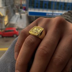 a close up of a person wearing a gold ring