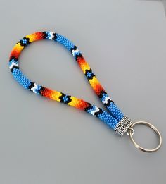 a multicolored lanyard with a metal hook on the end and a key chain attached to it