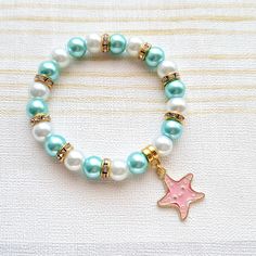 Cute starfish beaded stretch bracelet. Perfect gift for any animal lover for a birthday or a special gift. These are great gifts for little girls aswel as adults, you will find matching items in my store. *The bracelets are available for adults and children. Adults measure approximately 7.5inches unless a note is made. Children sizes vary depending on age of child. *The bracelets are made using 8mm glass pearl beads in any colours of your choice. which can be selected from the menu. *In between the beads are gold rhinestone beads to give a little sparkle.  *In the centre is a gold plated enamel starfish charm. *The charm measures approximately 2cms. ☆☆The bracelet comes presented in a little gift bag, I also have gift wrap and messages available to purchase from my store☆☆ If you have any Turquoise Starfish Beaded Bracelets, Ocean-inspired, Blue Starfish-shaped Beaded Bracelets As Gift, Ocean-inspired Turquoise Beaded Bracelets For Gift, Ocean-inspired Turquoise Starfish Beaded Bracelets, Playful Star Charm Jewelry For Gifts, Blue Beaded Bracelet With Starfish Charm As Gift, Blue Beaded Bracelets With Starfish Charm As Gift, Playful Jewelry With Star Charm For Gift, Ocean-inspired Blue Charm Bracelet For Gifts