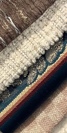 several different colored rugs are stacked together on top of each other in this close up photo