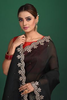 Be a vision of style and elegance at parties in this beautiful black embroidered organza saree. It comes with a red and pink stripes embroidered blouse. Shop designer sarees online in USA from Pure Elegance. DISCLAIMER:- The shown stitched blouse on the model is for display purpose only. The saree comes with a matching blouse and finished with fall and piko. Designer Art Silk Black Blouse Piece, Designer Black Art Silk Blouse Piece, Black Tissue Silk Traditional Wear For Wedding, Black Tissue Silk Traditional Wedding Wear, Black Silk Pre-draped Saree With Sheer Dupatta, Black Art Silk Traditional Wear With Sheer Dupatta, Black Organza Sharara For Festivals, Black Chanderi Blouse Piece With Traditional Drape, Black Art Silk Blouse Piece With Resham Embroidery