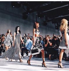 several models walking down the runway at a fashion show