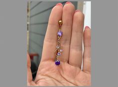 This dangly gold belly button ring features beautiful purple crystals in a long, chandelier shape. Gorgeous option for summer! Drop jaws with this body jewelry. Available with several metal & CZ colors (choose at checkout!) **PACKAGE INSURANCE: Please either upgrade to priority express shipping at checkout if you would like to insure your package OR you can also purchase insurance separately Insurance up to $100 for $1.50 here: https://www.etsy.com/listing/1296961518 Insurance up to $200 for $2.00 here: https://www.etsy.com/listing/1310991679 Details & Size: ♥ 316L Surgical Steel ♥ 14G, 10mm bar ♥ Externally Threaded ♥ Every purchase comes with an Elara gift box For sanitary purposes, piercing items are non-returnable, so please double check sizing and message me if you have any questions! Gold Hypoallergenic Belly Rings, Elegant Gold Belly Rings, Elegant Yellow Gold Body Jewelry For Gift, Dainty Gold Belly Rings For Wedding, Elegant Gold Belly Rings Gift, Elegant Yellow Gold Body Jewelry For Wedding, Elegant 14k Gold Belly Rings For Gift, Elegant 14k Yellow Gold Belly Rings, Elegant Internally Threaded Belly Rings As Gift