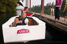 some people are riding in a boat on the water and one is holding a paddle