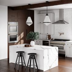 a kitchen with two stools next to an island in the middle of the room