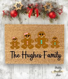 a door mat that says the hyggies family with three gingerbreads on it