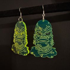 Creature From The Black Lagoon Dangly Earrings Made with fluorescent green acrylic to really fit the Creature vibe! These would be perfect for the Universal Monsters fan in your life! Hangs at 75mm drop from top of hook to bottom of earring. Shipped using Tracked 48 with Royal Mail. PLEASE BE AWARE! Wipe with a lightly dampened cloth only. Green Fun Plastic Jewelry, Fun Green Plastic Jewelry, Green Resin Fun Earrings, Creature From The Black Lagoon, The Black Lagoon, Laser Cut Jewelry, Universal Monsters, Black Lagoon, Dangly Earrings