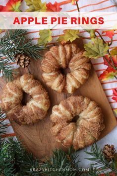 apple pie rings on a wooden cutting board with pine cones and leaves around the edges