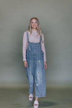 Frankie Denim Overalls are crafted from washed denim for a stylish, weathered look. Featuring an oversized and loose fit with adjustable straps and distressed details, these overalls are designed to provide a comfortable, personalized fit. Model Measurements: Hips 34” Waist 25” Bust 32” Height 5’6.5, wearing a size small Material: 100 Cotton Measurements XS: Hips: 42"| Length: 44" (taken from top of front of overalls to ankle cuff) S: Hips: 42"| Length: 44.5" (taken from top of front of overalls to ankle cuff) M: Hips: 46" | Length: 45" (taken from top of front of overalls to ankle cuff) L: Hips: 48" | Length: 45.5" (taken from top of front of overalls to ankle cuff) Trendy Light Wash Overalls For Fall, Trendy Distressed Light Wash Denim Jumpsuit, Light Wash Denim Overalls For Fall, Trendy Dark Wash Denim Jumpsuit With Frayed Hem, Trendy Light Wash Distressed Denim Jumpsuit, Ripped Denim Overalls For Spring, Casual Jeans With Suspenders In Medium Wash, Distressed Denim Jumpsuit In Denim Blue, Distressed Denim Blue Jumpsuit