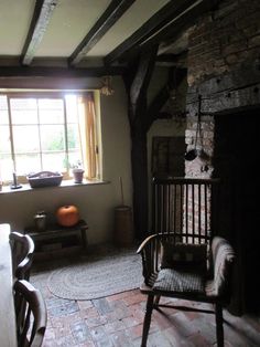 a living room filled with furniture and a fire place in front of a large window