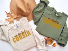 Thankful Vibes Cousin Sweatshirt Celebrate the spirit of Thanksgiving with our Thankful Vibes Cousin Sweatshirt! Perfect for bringing family together, this unisex pullover sweater is designed to spread warmth and gratitude. Featuring a trendy design with "Thankful Vibes" text, it's the ideal choice for cousins who want to share the holiday cheer in style. Unisex Thanksgiving Pullover Sweater Keep cozy this Thanksgiving with our Unisex Thanksgiving Pullover Sweater. The classic crewneck design and comfortable fit make it perfect for all-day wear, whether you're enjoying a family meal or watching the big game. Made for both men and women, this sweater is a versatile addition to any Thanksgiving wardrobe. Matching Cousin TShirt for Turkey Day Party Ideal for any situation, a unisex heavy blen Fall Cotton Tops With Lettering, Thanksgiving Letter Print Crew Neck Top, Thanksgiving Letter Print Cotton Tops, Fall Crew Neck Top With Lettering, Casual Crew Neck Tops For Thanksgiving, Casual Letter Print Tops For Thanksgiving, Casual Tops With Letter Print For Thanksgiving, Cousin Gifts, Family Together