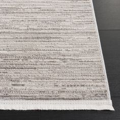 an area rug with grey and white stripes