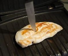 a piece of meat is being cooked on a grill with a spatula in it