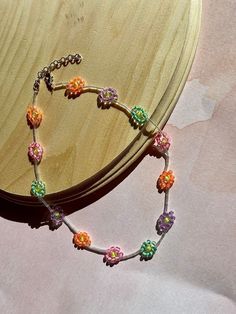 Orange, green, pink, and purple daisies with plastic separators in between Purple Daisy, Tucson Az, Beaded Necklaces, Flower Charm, Pink And Purple, Flower Necklace, Daisy Flower, Tucson, Chain Styles