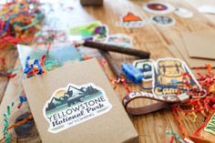 the yellow stone mountain park logo is surrounded by confetti and stickers on the table