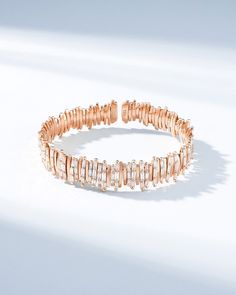 Discover the exquisite elegance of our Classic Gold Half Baguette Milli Bangle, set with 2.80 carats of baguette white diamonds. Crafted with individual segments of 18-karat spring gold wire, this bangle offers unparalleled flexibility and ease of wear. Each diamond is hand-set in Suzanne's distinctive signature style, making this bangle a truly unique statement piece. Details 18k yellow gold, rose gold or white gold 2.80 carats of white diamond baguettes Model is styling bangle in rose gold, on Elegant Bangle With Baguette Diamonds, Elegant Cubic Zirconia Bangle With Baguette Diamonds, Elegant Bangle With Baguette Cut Diamonds, Elegant Baguette Diamond Bangle, Elegant Party Bracelets With Baguette Diamonds, Rainbow Sapphires, Vs Diamond, Small Rose, Tennis Necklace