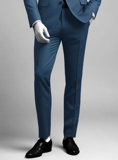 Bring some classic dignity, sophisticated style and warm touch to your work week wardrobe with our Napolean Casa Blue Wool suit. Crafted from wool blend, a long been piece with remarkable comfort and feel which complements the incredible versatility offered by its blue hue. Wear it with a matching waistcoat, a crisp white shirt, dotted light blue tie and brown dress shoes.  Look Includes   Napolean Casa Blue Wool Fabric  Two Button Jacket Style  Notch Lapel  Horn Royal Black Buttons  Single Vent  Three Cuff Buttons  Two Welted Back Pockets on Trousers    Click 'Customize Now' to modify the look if needed.   Lining: Viscose, Dry Clean, Pants can be lightly washed. Slim Fit Blue Suits For Workwear, Slim Fit Blue Suit For Work, Blue Suits With Flat Front For Work, Tailored Blue Suits For Office Wear, Blue Slim Fit Suit For Office Wear, Blue Slim Fit Suit For Office, Blue Workwear Suits With Pressed Crease, Blue Suits With Pressed Crease For Work, Blue Business Casual Suit