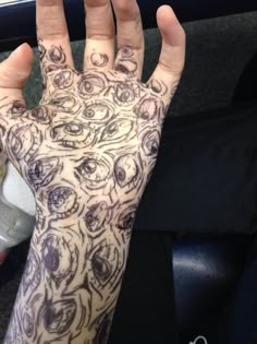 a person's hand with tattoos on it