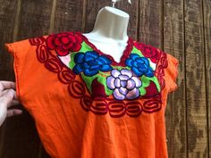 An ethnic, summer festive blouse that is embellished with floral embroidery. No tags - estimated size medium - large - please see measurements. Condition - good!.   Measurements taken across front laid flat Bust21" Shoulder to hem22" Waist20" Traditional Summer Tops For Festive Occasions, Cinco De Mayo Short Sleeve Blouse, Summer Festival Tops With Embroidered Border, Traditional Summer Blouse For Fiesta, Traditional Embroidered V-neck Top For Summer, Folk Style Festive Tops For Summer, Festive Embroidered Short Sleeve Top For Summer, Bohemian Tops For Fiesta And Festivals, Folk Style Festive Summer Tops