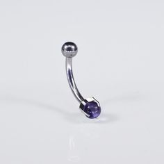 a metal object with a purple ball on it's end and an eyeball in the middle