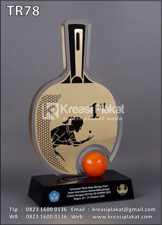 a trophy with an orange ball on it