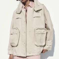 Brand New Cream Cargo Jacket/Coat/Trench Oversized With Large Pockets And Zippers. Hooded. Oversized Khaki Outerwear With Flap Pockets, Oversized Khaki Outerwear With Patch Pockets, Oversized Khaki Utility Jacket With Pockets, Oversized Utility Shacket, Oversized Khaki Shacket With Pockets, Oversized Khaki Utility Jacket With Multiple Pockets, Oversized Khaki Shacket With Flap Pockets, Oversized Utility Outerwear With Pockets, Beige Utility Outerwear With Side Pockets