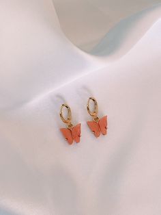 Elegant Pearlescent Butterfly Huggie Earrings. Hoops are made of gold plated brass, and each dainty butterfly charm is made of a pearlescent pewter acrylic, with a gold or rhodium backing. Summer Butterfly Charm Earrings, Pink Butterfly Charm Earrings, Rose Gold Butterfly Charm Earrings For Gift, Rose Gold Butterfly Charm Earrings As Gift, Cute Gold Butterfly Jewelry, Rose Gold Earrings With Butterfly Charm As Gift, Rose Gold Hypoallergenic Butterfly Earrings, Delicate Gold Earrings With Butterfly Charm, Pink Butterfly Jewelry For Summer