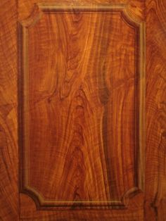 a wooden door with an ornate frame on the front and side panel inlays