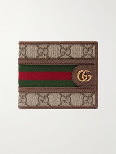 Gucci's 'Ophidia' wallet is inspired by accessories from the house's archive. It's made from coated-canvas printed with the iconic 'GG' monogram, which matches the burnished gold-tone hardware, and is centred by red and green webbing stripes. Gucci Classic Wallets With Logo, Designer Brown Rectangular Wallet, Gucci Brown Wallets With Interior Card Slots, Brown Gucci Wallets With Interior Card Slots, Designer Rectangular Wallets With Logo, Luxury Brown Wallets With Logo, Classic Gucci Wallets With Logo, Gucci Bifold Wallet For Everyday Use, Brown Rectangular Wallet With Logo