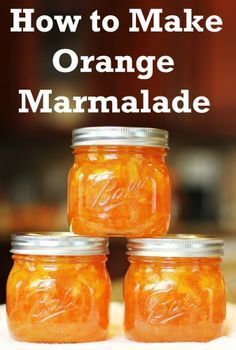 three jars filled with orange marmalade sitting on top of a table