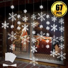 the window is decorated with snowflakes and lights