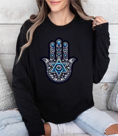 Hope you liked our Evil Eye Talisman Protection Long Sleeve T-Shirt, Shirt  for more Jewish gift click the linkhttps://happyartbylora.etsy.com Am Yisrael Chai! Welcome to my store! Our shirts are designed to add joy and color to your life. Feel free to ask me anything you may need help with, I'm happy to assist you in any way. Happy Art by Lora - Brightens up your day Long sleeve shirt made with 100% ring-spun cotton Come packed with softness and style. Each tee features garment-dyed fabric comes with a relaxed fit for total comfort in any casual setting. .: 100% ring-spun cotton .: Medium fabric (6.1 oz/yd² (206.8 g/m .: Classic Fit .: Sewn-in twill label Gift Black Long Sleeve Shirt, Black Long Sleeve Shirt Gift, Long Sleeve Graphic Tee T-shirt As Gift, Blue Long Sleeve T-shirt For Gift, Blue Long Sleeve T-shirt As Gift, Long Sleeve Tops With Graphic Print, Long Sleeve Screen Print T-shirt As Gift, Long Sleeve Screen Print T-shirt Gift, Blue Long Sleeve Top As Gift